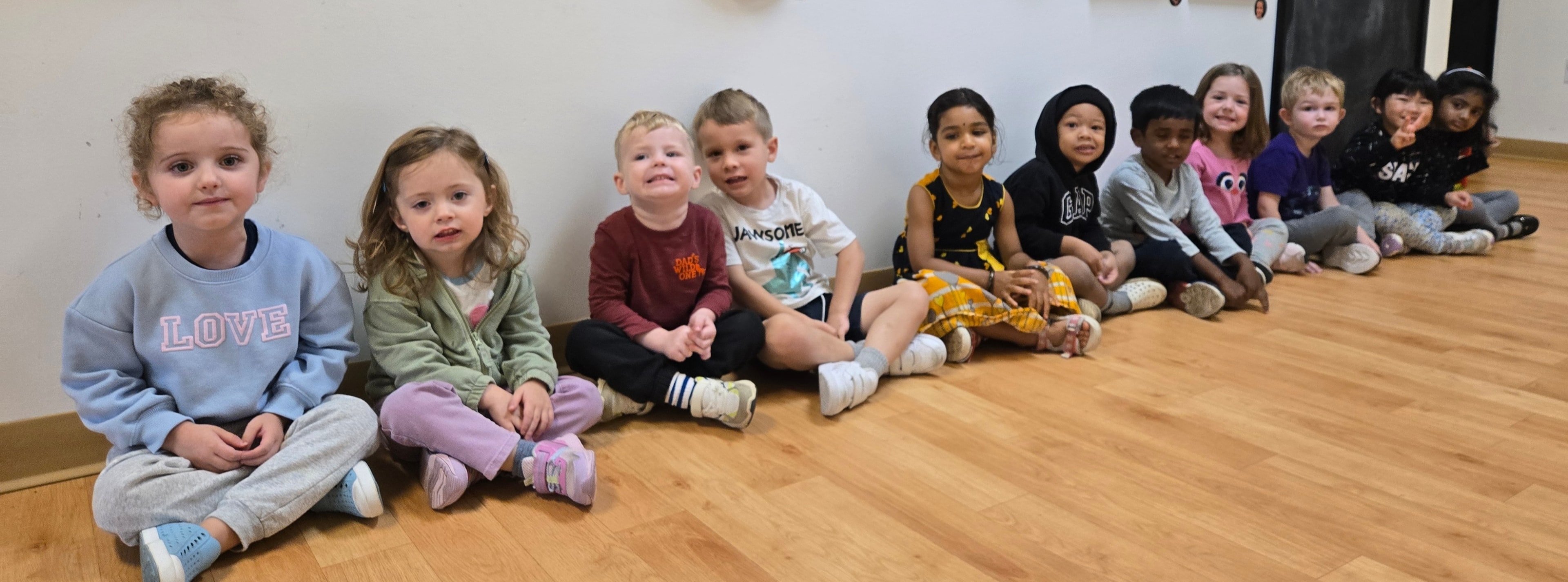 Children playing an educational card matching game at Curious Kids Preschool